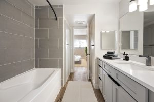 a bathroom with a tub and a shower stall at The Palm Haven
