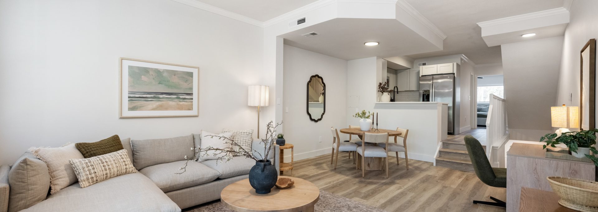 a living room with a ceiling fan and hardwood floors at The Palm Haven
